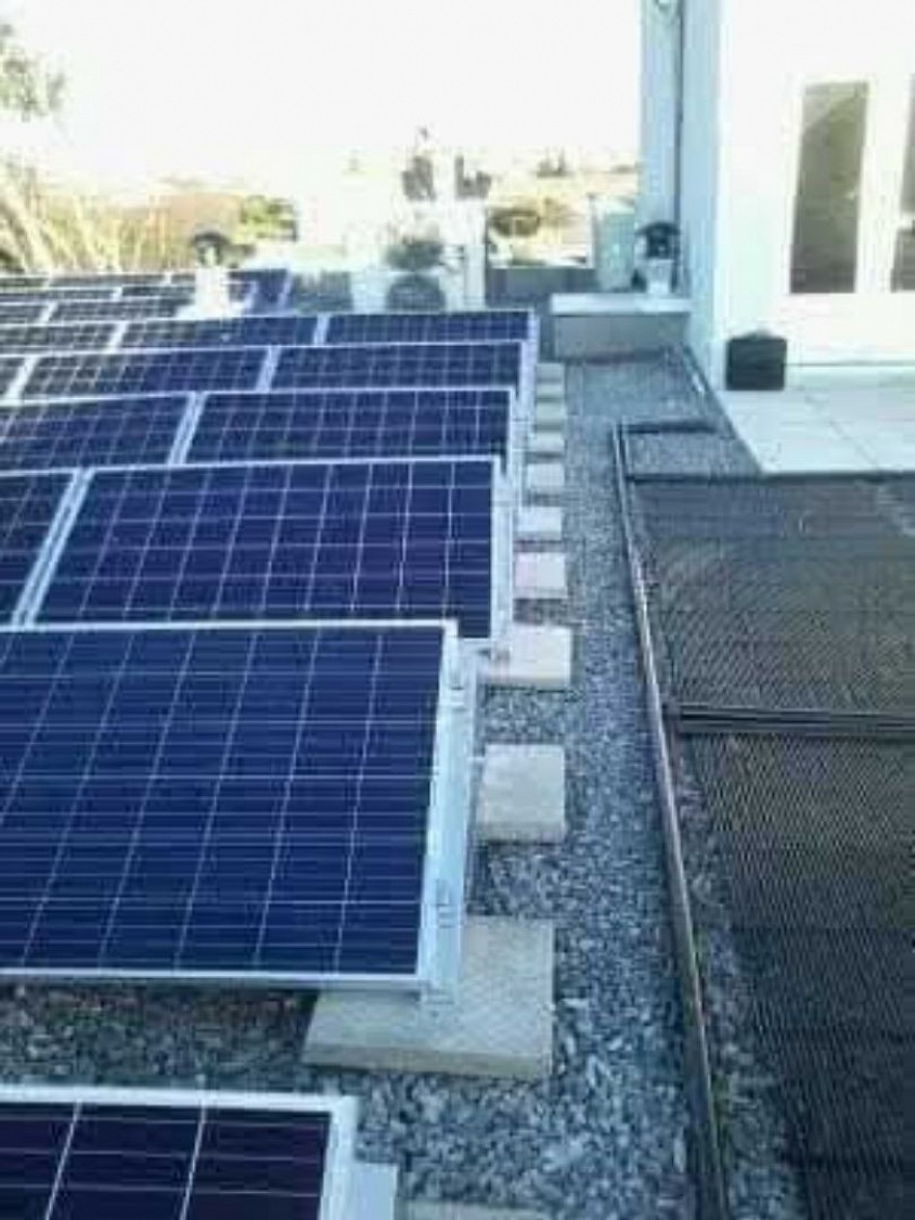 Added Canadian solar panel intergrations part of 150kw system on Health Centre top concrete floor.